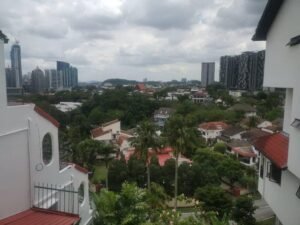 Front view of a luxurious 3-storey bungalow in Jelutong Villas, Damansara Heights, featuring modern architectural design and a beautifully landscaped garden."