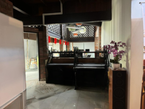Spacious living area of a partially furnished 6+1 bedroom home in Bukit Tunku, featuring modern and classic design elements.