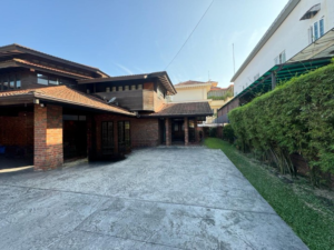 Spacious living area of a partially furnished 6+1 bedroom home in Bukit Tunku, featuring modern and classic design elements.