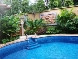 Interior view of a luxurious 4+2 bedroom bungalow in Bukit Tunku, highlighting the private swimming pool and elegant design.