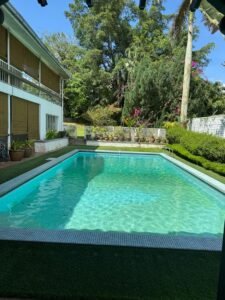 Comfortable bungalow for rent in Bukit Tunku, Kuala Lumpur. 5 bedrooms, 7 bathrooms, 1 maid room, garden, balcony, swimming pool, and parking. Rental price RM 25,000/month. Spacious layout with modern finishes and greenery views.