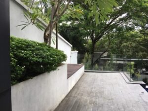 Front view of a luxurious 5-storey bungalow in Bukit Tunku, featuring modern architectural design, a private swimming pool with city views, and surrounded by lush greenery