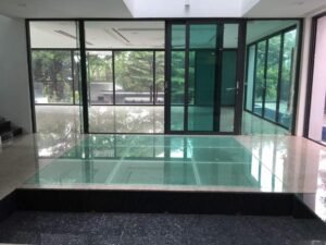 Front view of a luxurious 5-storey bungalow in Bukit Tunku, featuring modern architectural design, a private swimming pool with city views, and surrounded by lush greenery