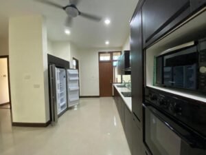 Front view of a luxurious 4-bedroom bungalow in Duta Nusantara, Sri Hartamas, featuring modern architectural design and a beautifully landscaped garden