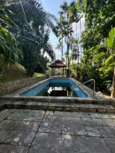 Elegant bungalow for rent in Bukit Tunku, Kuala Lumpur, featuring a private swimming pool, modern interiors, and lush green surroundings.