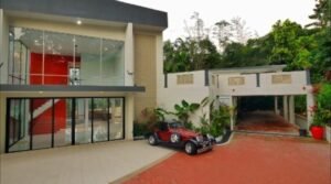 Exterior view of a luxurious bungalow in Jalan Bukit Tunku, Kuala Lumpur, featuring a swimming pool, garage, and spacious interiors