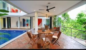 Exterior view of a luxurious bungalow in Jalan Bukit Tunku, Kuala Lumpur, featuring a swimming pool, garage, and spacious interiors