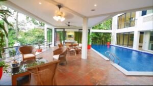 Exterior view of a luxurious bungalow in Jalan Bukit Tunku, Kuala Lumpur, featuring a swimming pool, garage, and spacious interiors