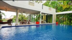 Exterior view of a luxurious bungalow in Jalan Bukit Tunku, Kuala Lumpur, featuring a swimming pool, garage, and spacious interiors