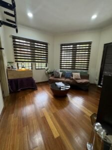 Front view of a luxurious bungalow in Bukit Damansara, featuring a mature landscaped garden and elegant architectural design.