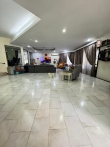 Front view of a luxurious bungalow in Bukit Damansara, featuring a mature landscaped garden and elegant architectural design.