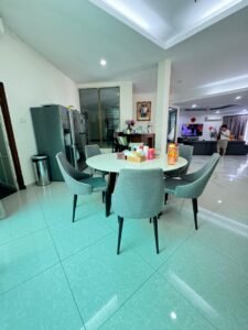 Front view of a luxurious bungalow in Bukit Damansara, featuring a mature landscaped garden and elegant architectural design.