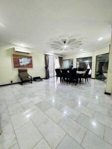 Front view of a luxurious bungalow in Bukit Damansara, featuring a mature landscaped garden and elegant architectural design.