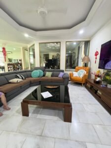 Front view of a luxurious bungalow in Bukit Damansara, featuring a mature landscaped garden and elegant architectural design.