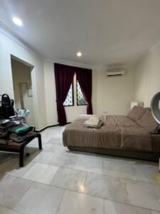 Front view of a luxurious bungalow in Bukit Damansara, featuring a mature landscaped garden and elegant architectural design.