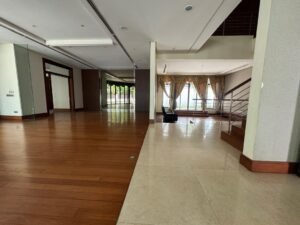 Elegant living area with high ceilings and natural light in Bukit Tunku bungalow