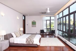 Front view of a luxurious 6-bedroom bungalow in Damansara Heights, featuring a private swimming pool and modern architectural design.