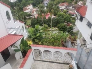 Front view of a luxurious 3-storey bungalow in Jelutong Villas, Damansara Heights, featuring modern architectural design and a beautifully landscaped garden."