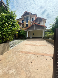 Front view of a luxurious 3-storey bungalow in Bukit Tunku, featuring a beautifully landscaped garden and elegant architectural design