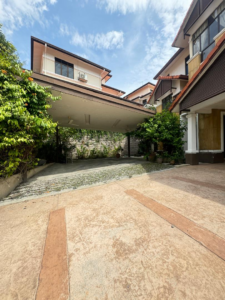 Front view of a luxurious 3-storey bungalow in Bukit Tunku, featuring a beautifully landscaped garden and elegant architectural design