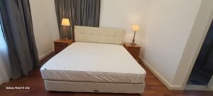 Modern fully furnished one-bedroom condominium in Mutiara Damansara featuring spacious living area, private balcony, and access to swimming pool and tennis courts near popular shopping destinations
